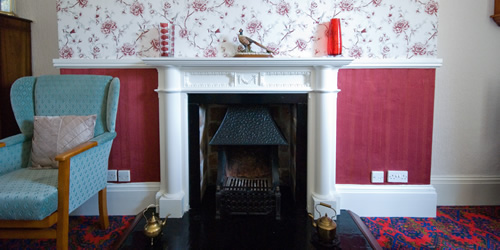 Traditional fireplace at Waungron Mansion Care Home